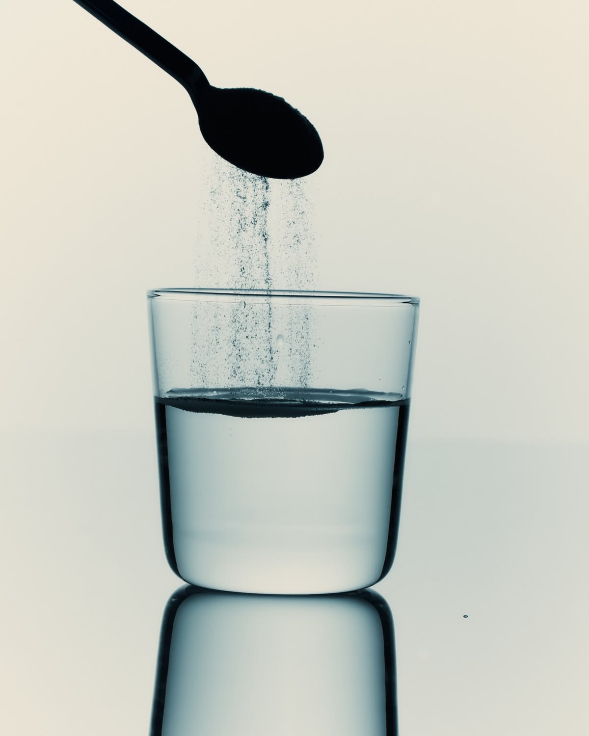 Glass of water being poured, representing hydration for ammonia breath