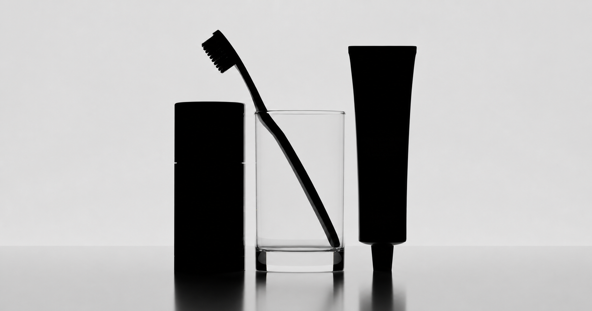 Toothbrush, toothpaste, and glass in silhouette